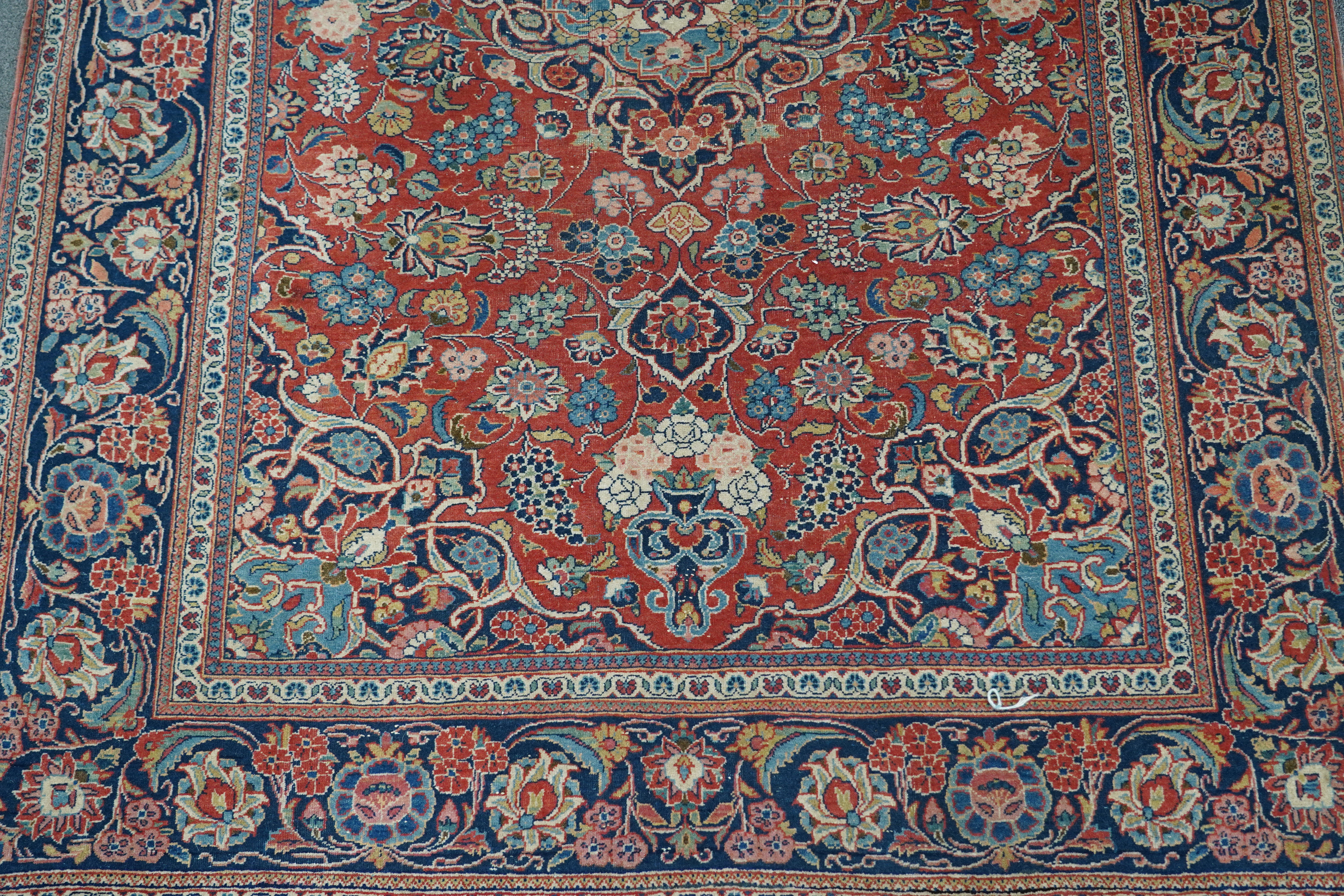 A pair of antique Tabriz brick red ground rugs, 200 x 136cm. Condition - fair